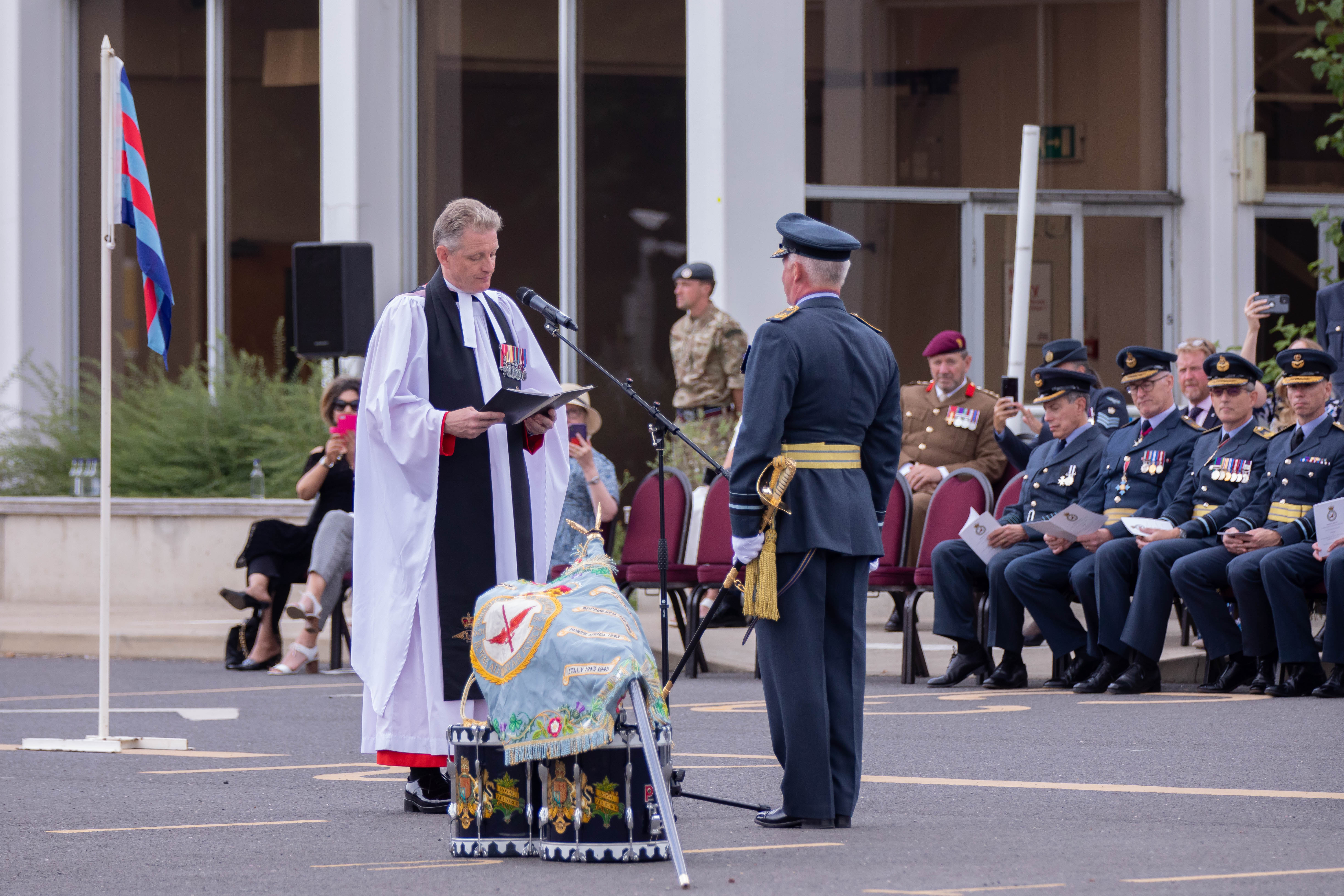 Image shows aviator stood before Padre during service.